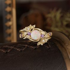 Opal ring with amethyst and gold leaf designs, part of the Rose Blossom collection. Whimsigoth Engagement Ring, Halloween Ring, Rose Blossom, Three Stone Rings, Opal Ring, Engagement Ring Wedding Band, Mens Wedding Rings, Bridal Sets, Opal Rings