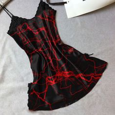 Indulge in luxurious comfort and stunning style with our Women's Red Lace Nightgown. Made with a smooth, stretchy, and lightweight fabric, this chemise offers a comfortable fit for all night wear. The combination of red lace and gothic symbols is sure to turn heads. With a slim fit design and plunging V-neckline, this chemise will accentuate your curves in all the right places. Perfect for a romantic evening, the dual side slits add a touch of sexiness to this beautiful piece. Exquisite Material Party Chemise With Built-in Bra And Spaghetti Straps, Red V-neck Slip Dress For Sleep, Red V-neck Summer Nightgown, Night Out Camisole Chemise With Built-in Bra, Red Summer Sleepwear, Sleeveless Satin Sleepwear For Night Out, Elegant Red Nightgown For Bedtime, Stretch Mini Dress With Spaghetti Straps For Loungewear, Fitted Summer Night Chemise