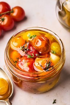 a glass jar filled with lots of different types of food on top of a table