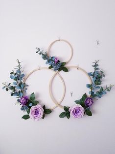 two hoop wreaths with purple flowers and greenery