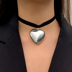 Features: Expertly crafted with soft and luxurious velvet material, this choker necklace features a big heart pendant and elegant weave design. The adjustable chain ensures a perfect fit for all. Perfect for adding a touch of glamour to any outfit, especially for the upcoming New Year celebrations. Trendy Adjustable Heart Necklace For Party, Adjustable Trendy Heart Necklace For Party, Trendy Party Heart Choker Necklace, Trendy Party Choker With Heart Charm, Trendy Heart Charm Choker For Party, Trendy Party Choker With Heart Pendant, Trendy Heart Shaped Metal Choker, Trendy Heart-shaped Metal Choker, Elegant Metal Heart Choker Necklace