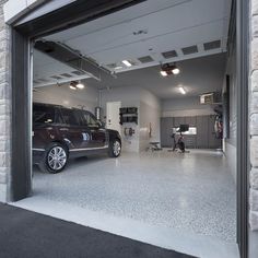 an open garage with two cars parked in it