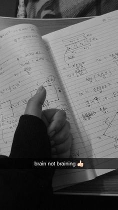 someone is writing on a notebook while holding their hand up to the page that says, brain not training