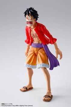 the action figure is wearing sandals and a red jacket with purple trims on it