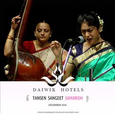 two women standing next to each other holding musical instruments