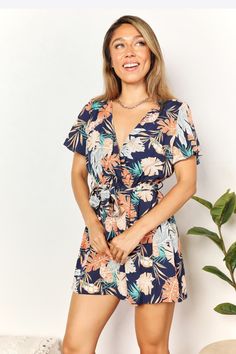 Double Take Botanical Print Surplice Neck Tie Waist Romper 
https://mygoodyshop.com/products/double-take-botanical-print-surplice-neck-tie-waist-romper  
MyGoodyShop.com
https://mygoodyshop.com 
This botanical print romper features a surplice neckline, adding a touch of elegance and allure. The tie waist detail enhances your figure and provides a flattering fit. The short flutter sleeves add a playful and feminine touch to the romper. With i... #Bestseller #mygoodyshop #luxury #fashion #shopn... Tropical Romper, Floral Print Rompers, Surplice Neckline, Baywatch, Double Take, Printed Rompers, Botanical Print, Sleeved Romper, Short Rompers