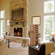 a living room filled with furniture and a fire place in the middle of a room