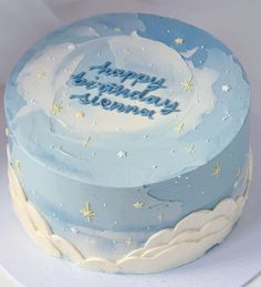 a blue and white birthday cake with stars on it