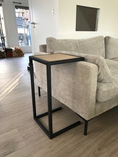 a living room with a couch and table on the floor in front of it's sofa