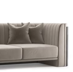 a beige couch with two pillows on it's back and one pillow in the middle