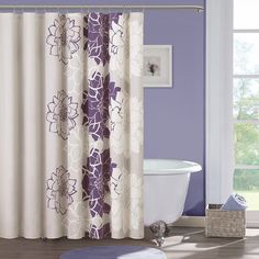 a bathroom with purple and white shower curtains