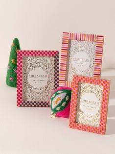 three different colored greeting cards sitting next to each other on top of a white surface