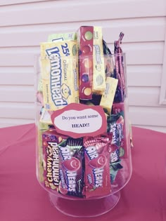 a clear container filled with candy on top of a table