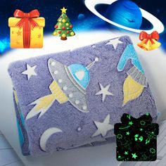 an image of a blanket with outer space designs on it and presents around the corner