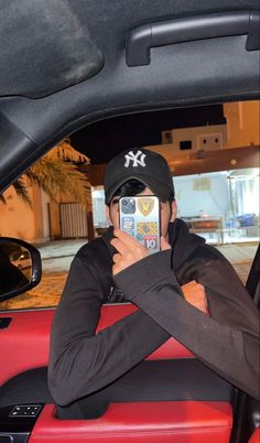 a man taking a selfie in the back seat of a car with his cell phone