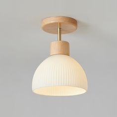 a wooden light fixture hanging from the ceiling