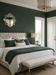 a bedroom with green walls, white bedding and a large mirror on the wall