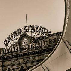 an old train station with a clock on it's roof and the union station sign