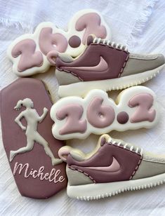 some cookies that are shaped like shoes with the word nike on them and one is running