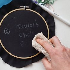 a person cleaning a black plate with a cloth