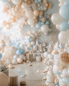 a room filled with balloons and confetti on the walls, along with seashells