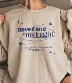 a woman wearing a sweatshirt that says meet me at midnight