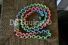 an assortment of colorful bracelets sitting on top of a wicker table