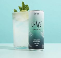 a can of crave next to a glass filled with ice and mint on a table