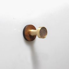 a door knob with a wooden handle on a white wall