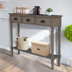 a console table with two drawers and a basket on the bottom shelf next to it