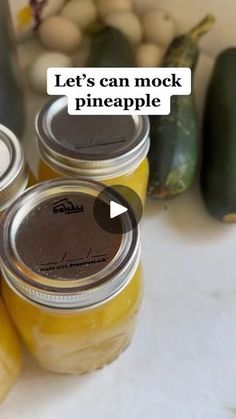 jars filled with pickles sitting on top of a table