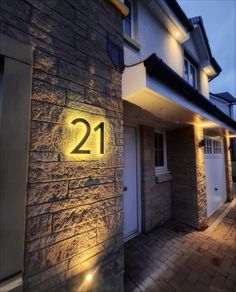 a house that has the number 21 lit up on it's front door at night