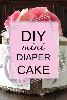 diy mini diaper cake with pink roses in the middle and text overlay