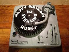 a birthday cake that is on top of a turntable