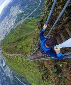 a man standing on top of a glass walkway