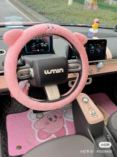 the interior of a car with pink carpet and steering wheel cover on it's dashboard