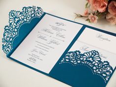 a blue and white wedding card with lace