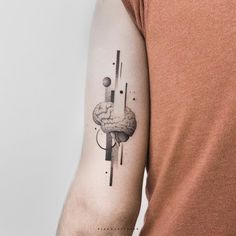 a man with a tattoo on his arm has a black and white image of an object