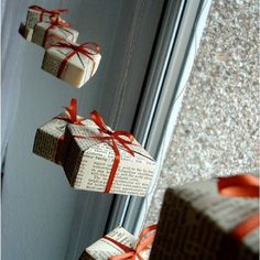 three wrapped presents hanging from strings on a door