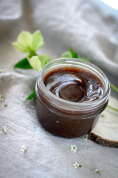 a jar filled with chocolate sauce sitting on top of a table