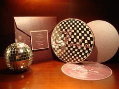 a disco ball, cd's and other items on a table