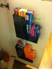 a bathroom with toilet paper and toothbrushes hanging on the wall next to it