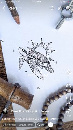 a drawing of a turtle on paper next to a wooden bead necklace and pen