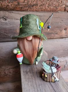 a wooden table topped with a green hat and doll