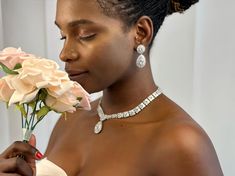 a woman holding a bouquet of flowers in her hand