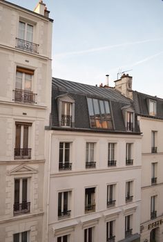 an apartment building with many windows and balconies