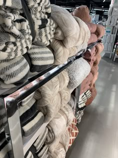 a rack full of blankets in a store