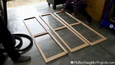 a man working on some wood in a garage