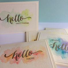 three cards with watercolor designs on them