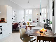 a living room filled with furniture and a wooden table